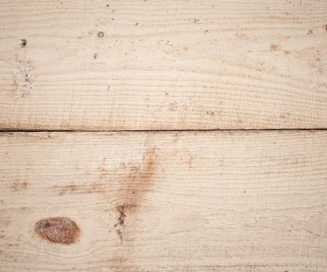 Background of textured surface of wooden boards with linear pattern and brown spots