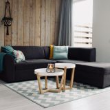light candle on round white coffee table and sectional sofa